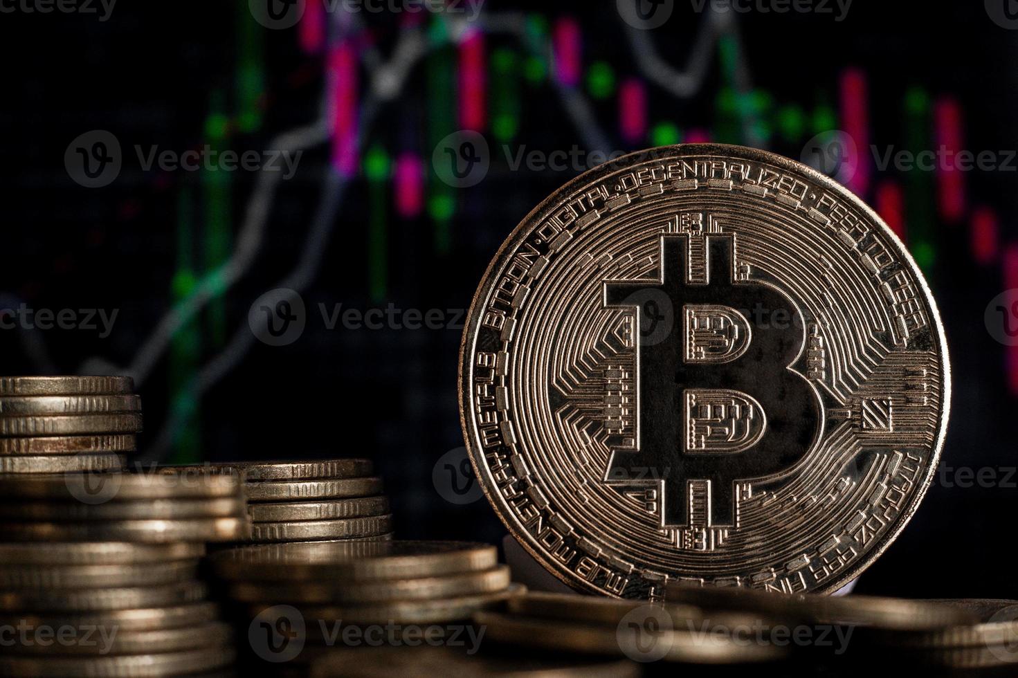 Bitcoin investments and taxes concept. Bitcoin gold coin and defocused chart background. Virtual cryptocurrency concept. photo
