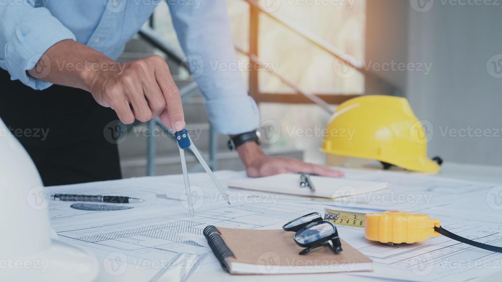 Engineering man working together looking blueprint are discussing construction from a plan to follow the project to build an industrial plant at site. Worker concept. photo