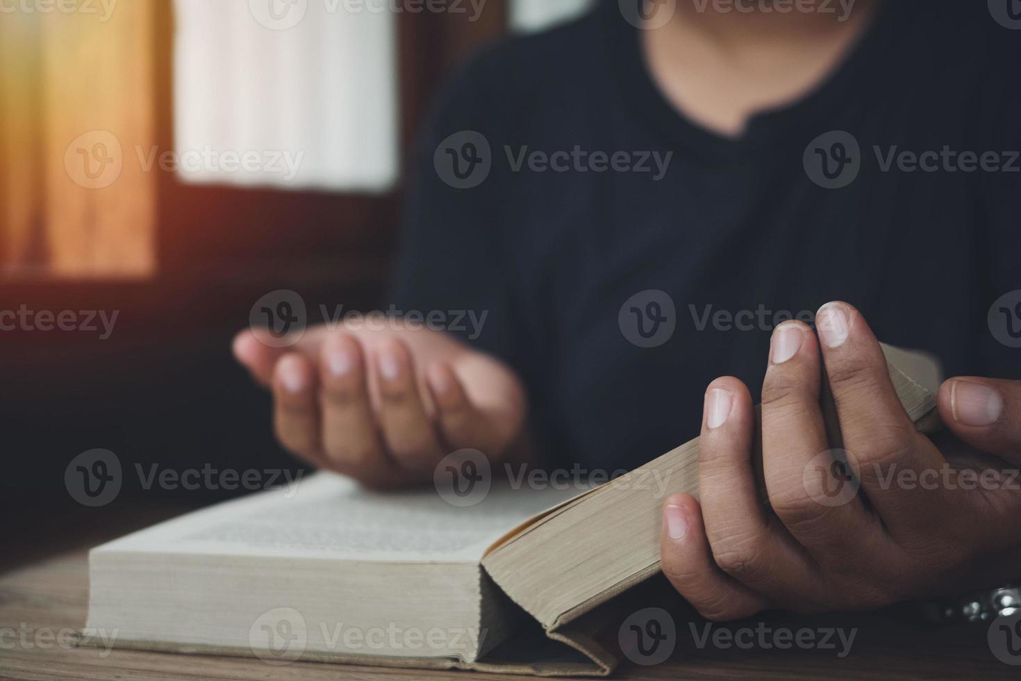Man prayer on bible, worship and religion. concept for faith, old Bible. copy space photo