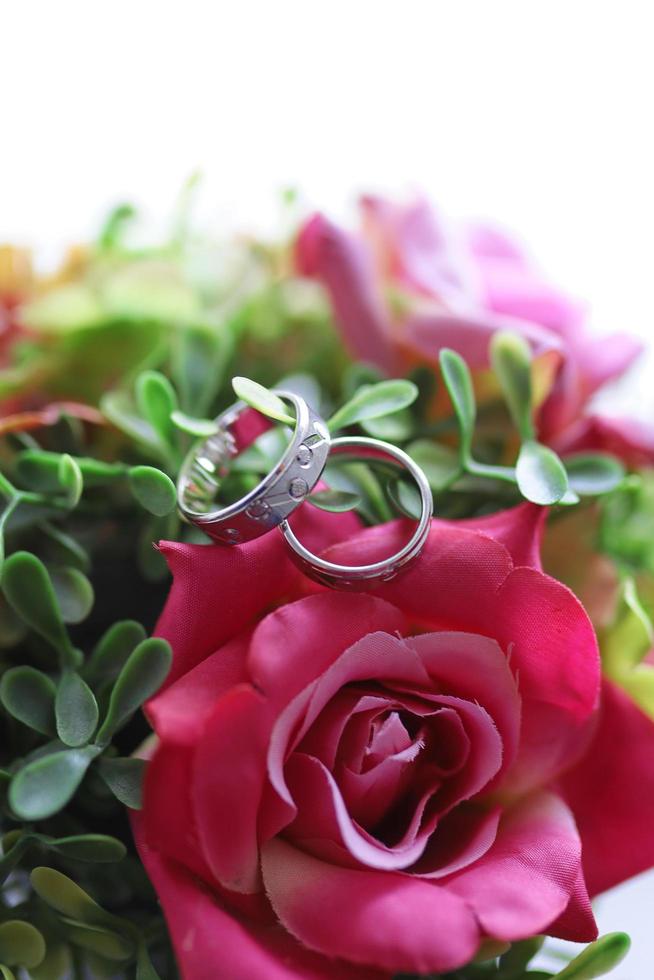 A pair of wedding rings on flower photo