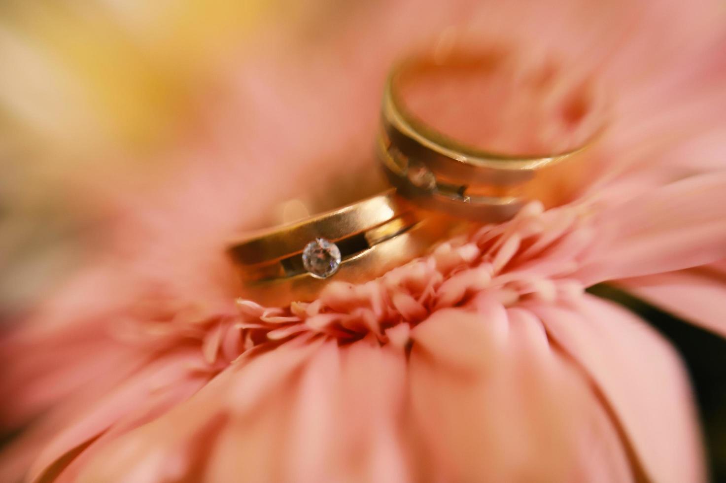 A pair of wedding rings on a bouquet of flowers photo