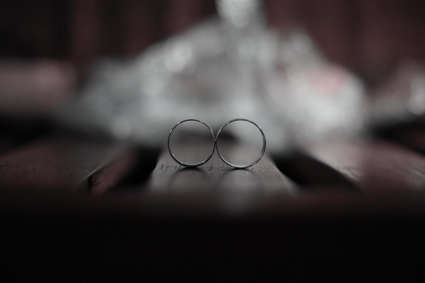 A pair of wedding rings on a wood photo