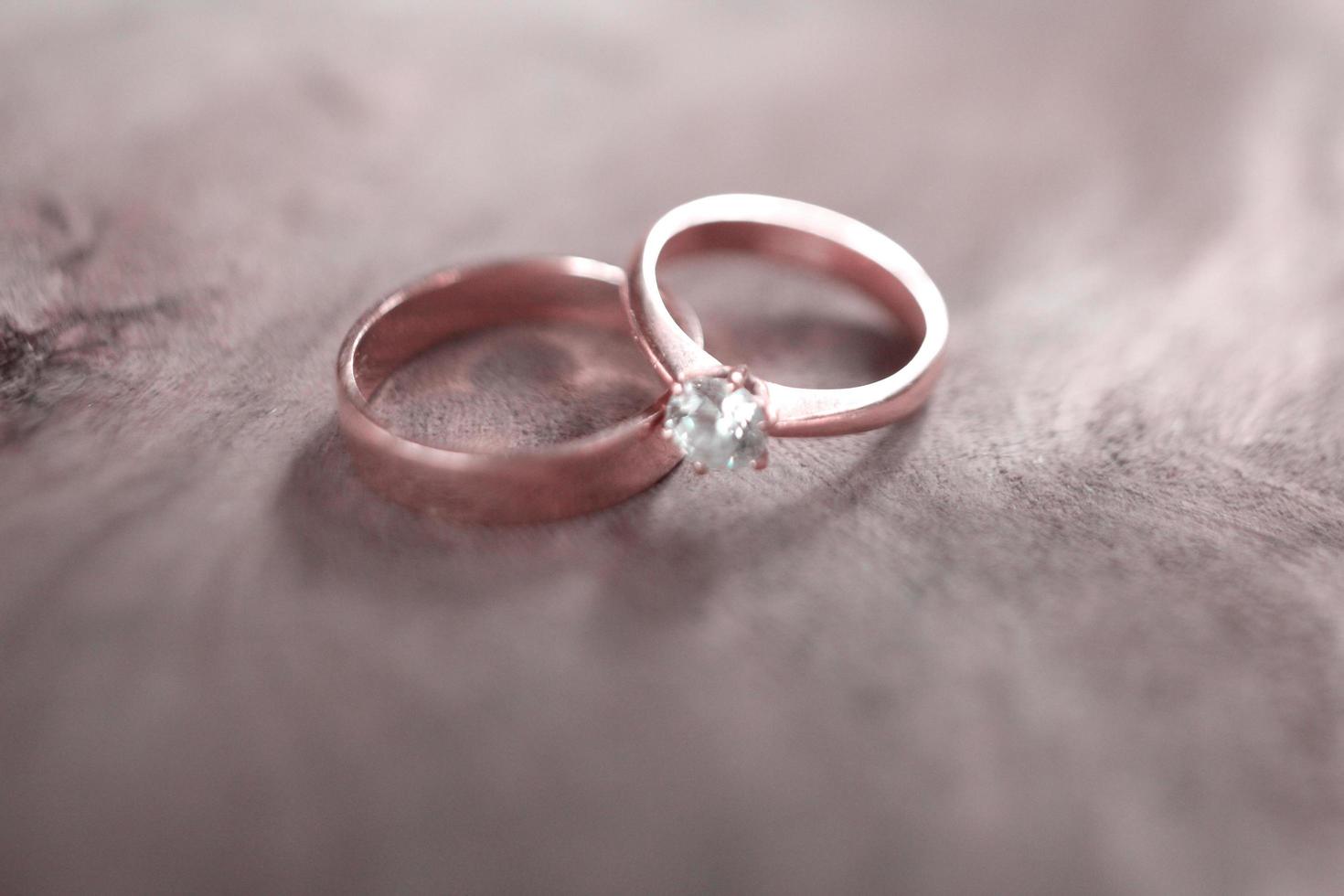A pair of wedding rings on a wood photo