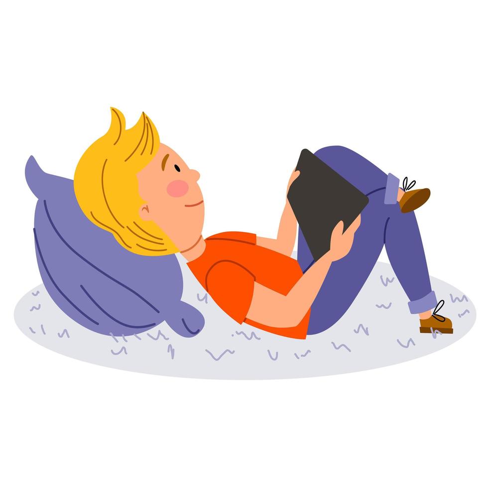 A smiling blonde boy lying on a pillow playing with her tablet. vector