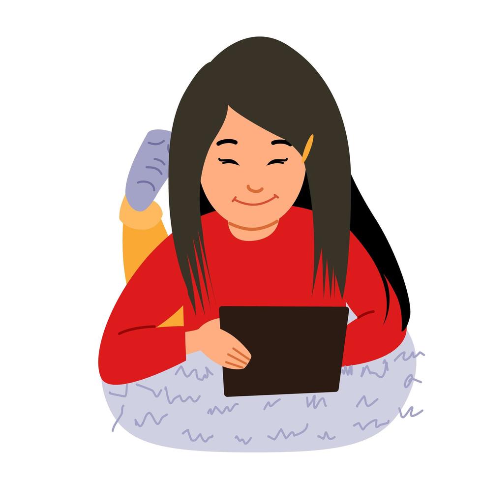 A smiling baby lying on her stomach and playing with her tablet. vector