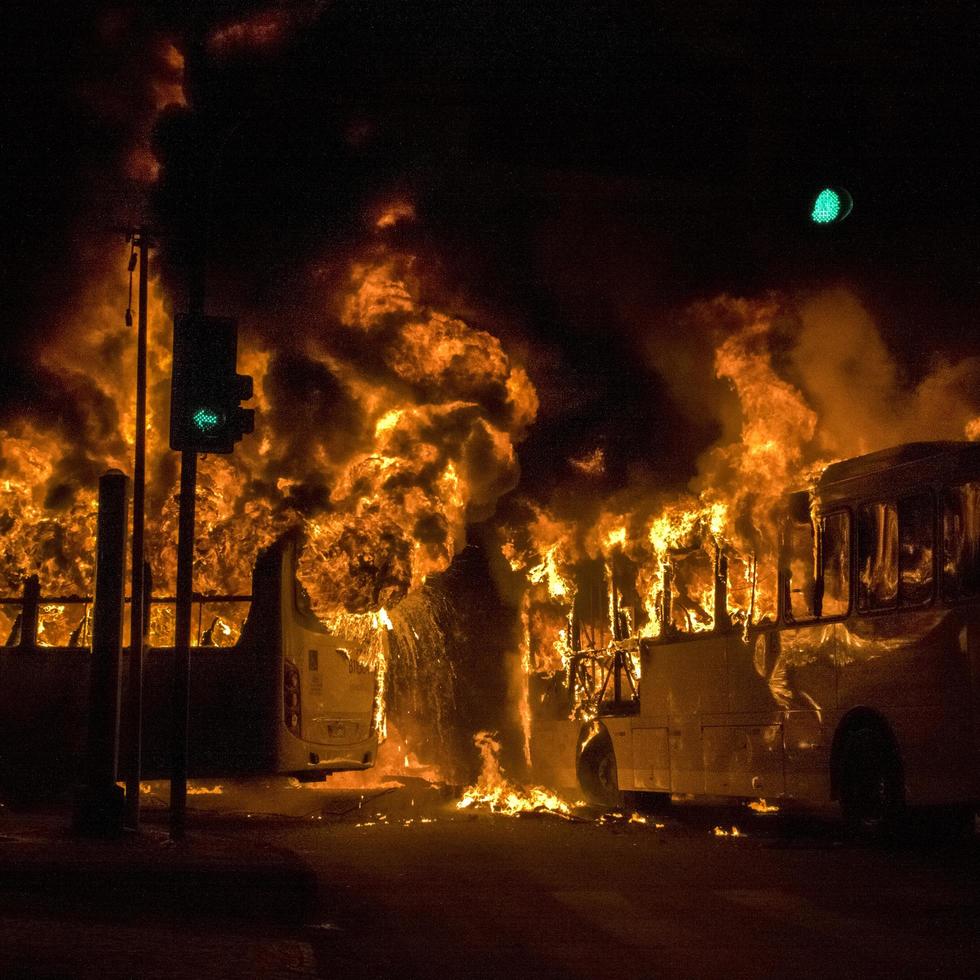 protesters set fire to public transport buses in the city of Rio de Janeiro, Brazil. photo