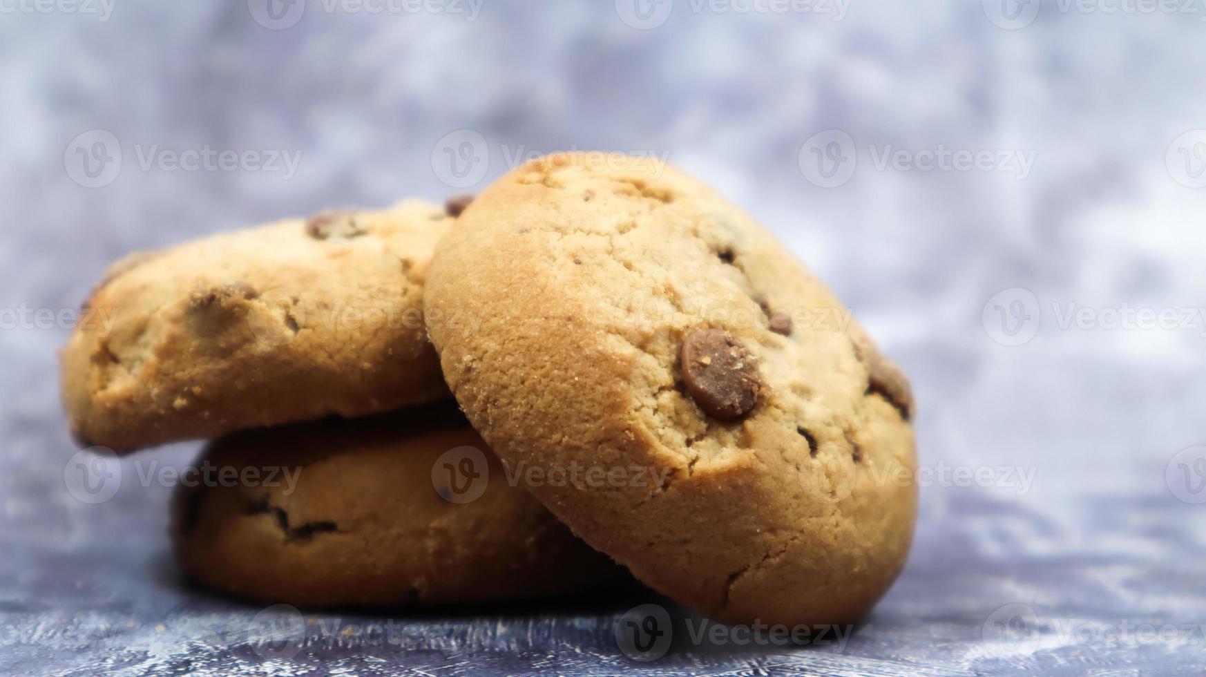 Soft, freshly baked chocolate chip cookies on a gray marble kitchen countertop. American traditional sweet pastry pastry, delicious homemade dessert. Culinary background. photo