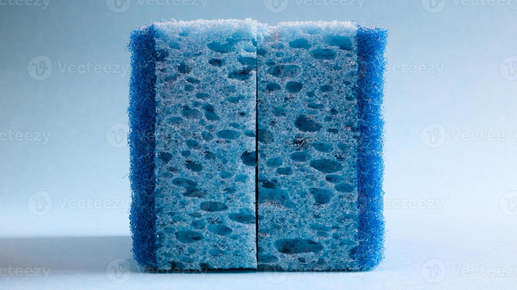 Two blue sponges used for washing and erasing dirt used by housewives in everyday life. They are made of porous material such as foam. Detergent retention, which allows you to spend it economically photo