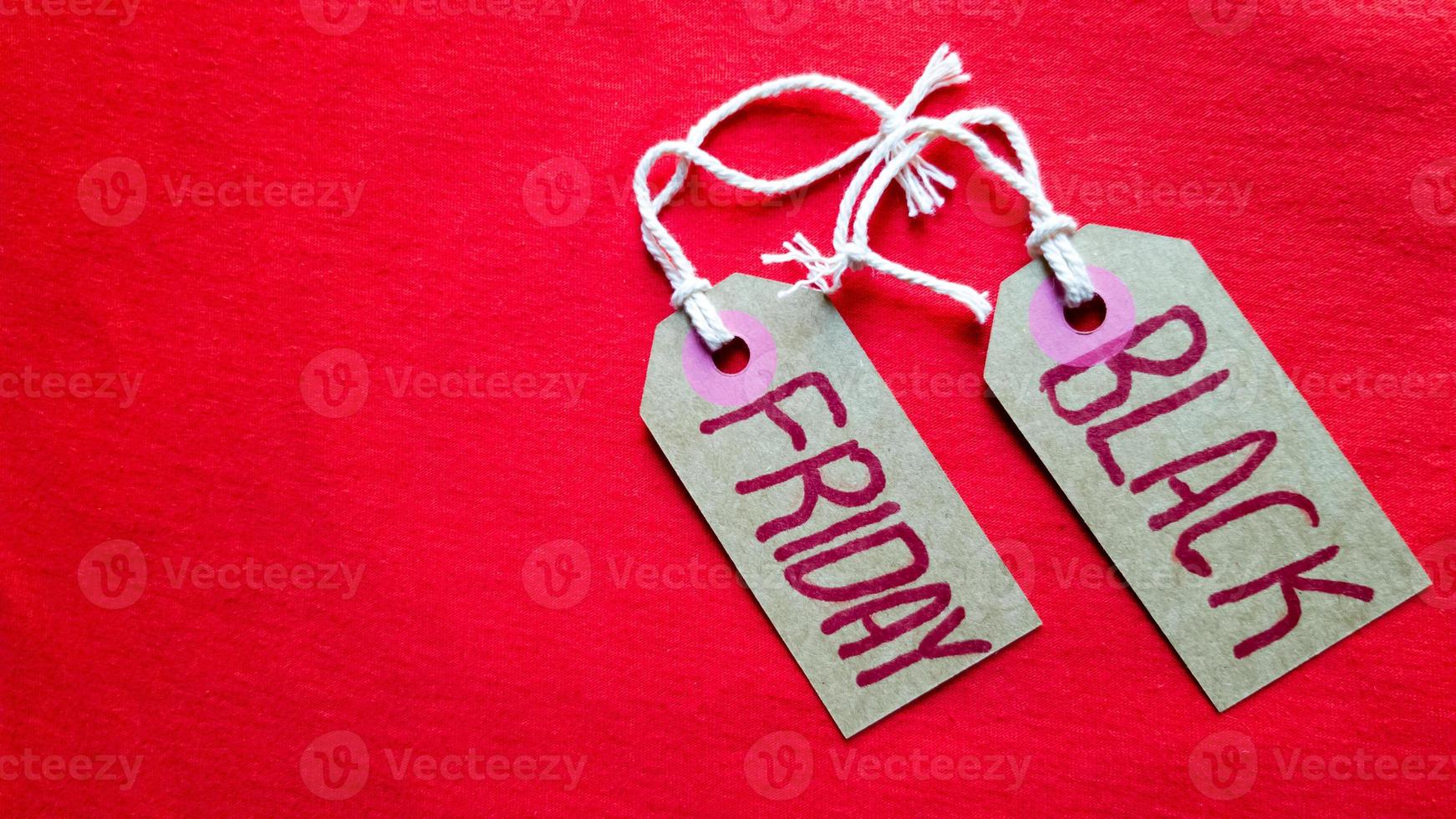 Label paper with the text black friday on a red background. Shopping, sale concept. Close-up, copy space. photo