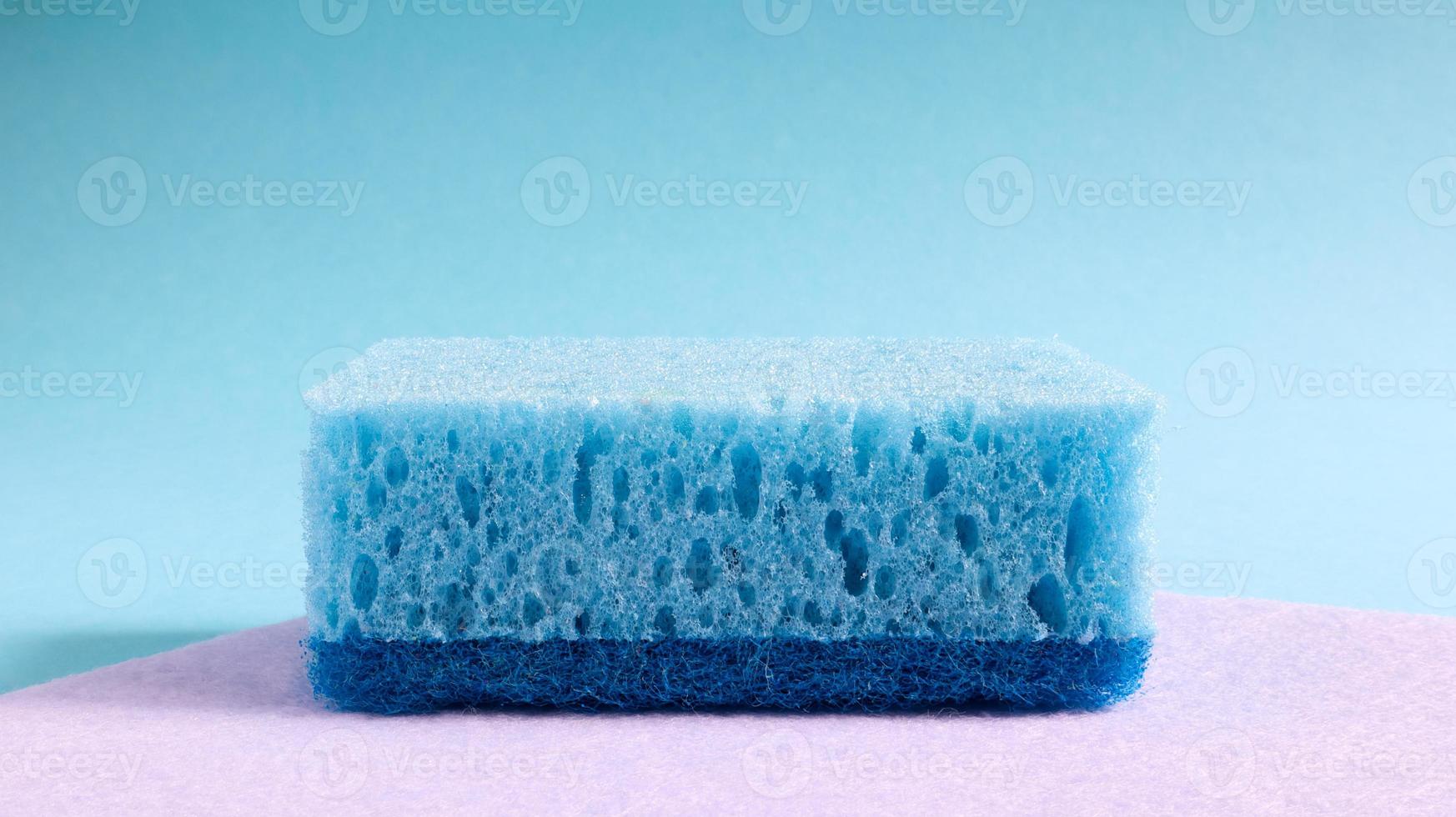 One blue sponge used to wash and erase dirt used by housewives in everyday life. They are made of porous material such as foam. Detergent retention, which allows you to spend it economically photo