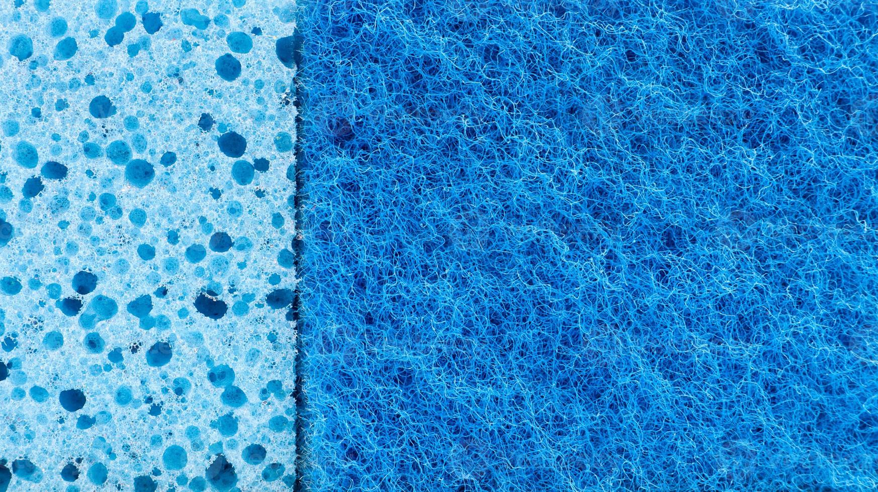 Background in the form of a porous structure in blue. Macro sponge. Close up blue sponge surface for textured background. copy space. photo