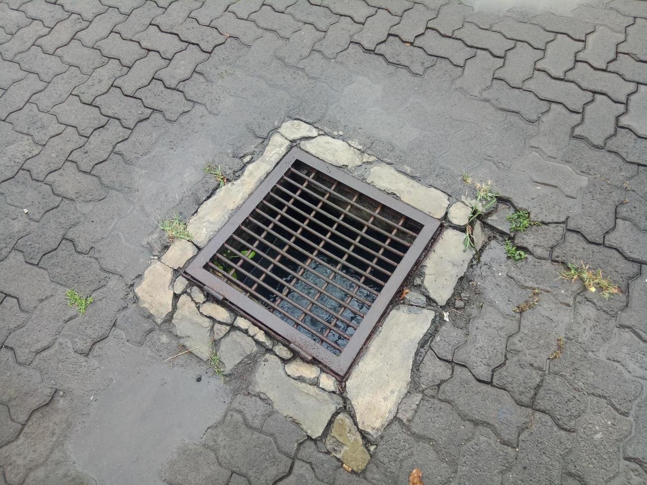 drain hole covered with iron trellis 5540324 Stock Photo at Vecteezy