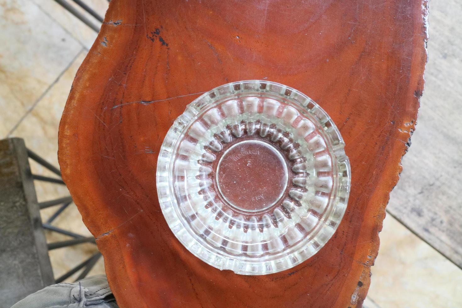 glass ashtray on wooden table photo