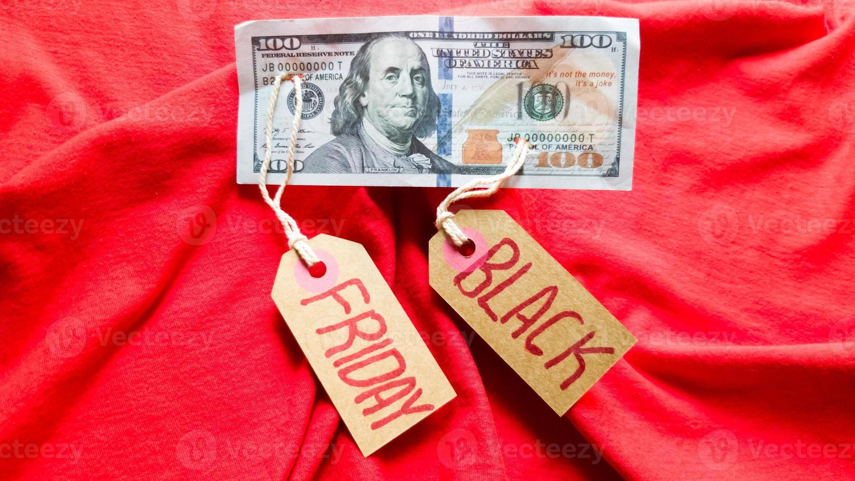 Label paper with the text black friday on a red background with american dollars. Shopping, sale concept. Close-up, copy space photo