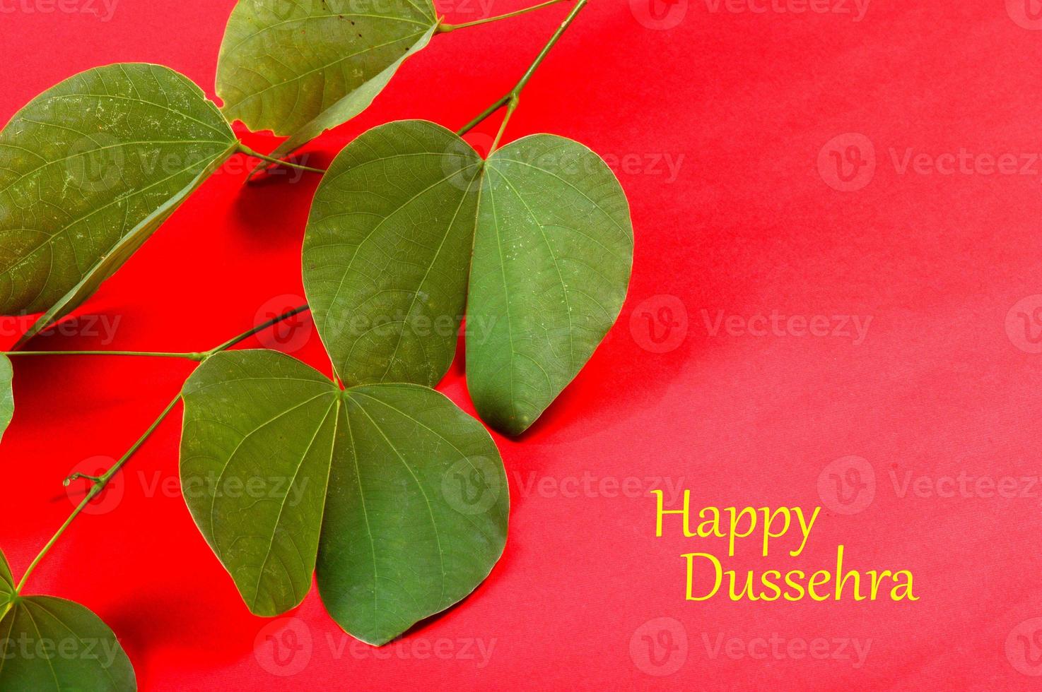 Indian Festival Dussehra, showing golden leaf on red background. Greeting card. photo