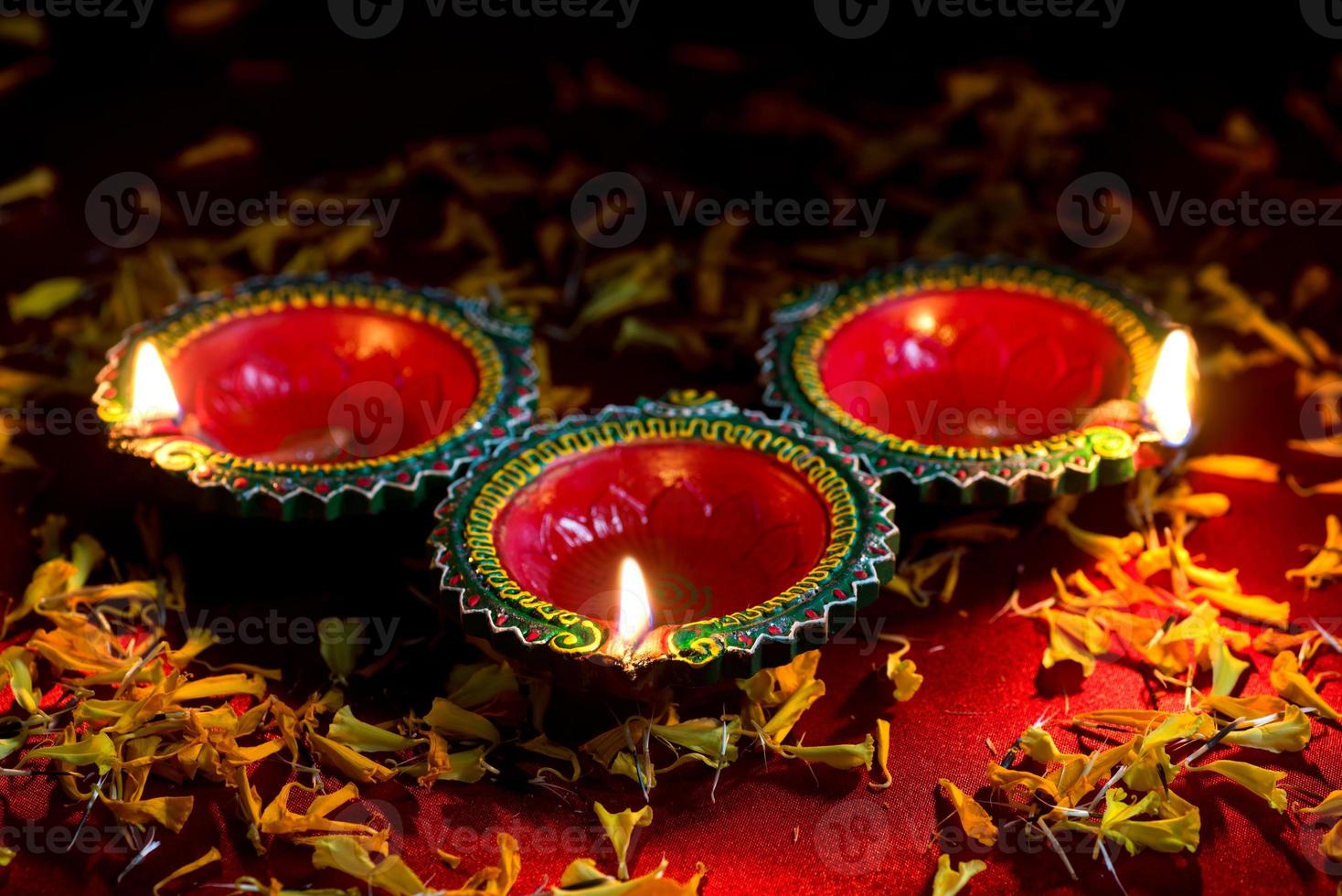 Happy Diwali - Clay Diya lamps lit during Diwali celebration. Greetings Card Design of Indian Hindu Light Festival called Diwali photo