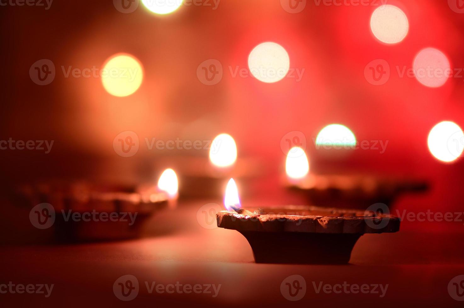 Clay diya lamps lit during Diwali Celebration. Greetings Card Design Indian Hindu Light Festival called Diwali photo