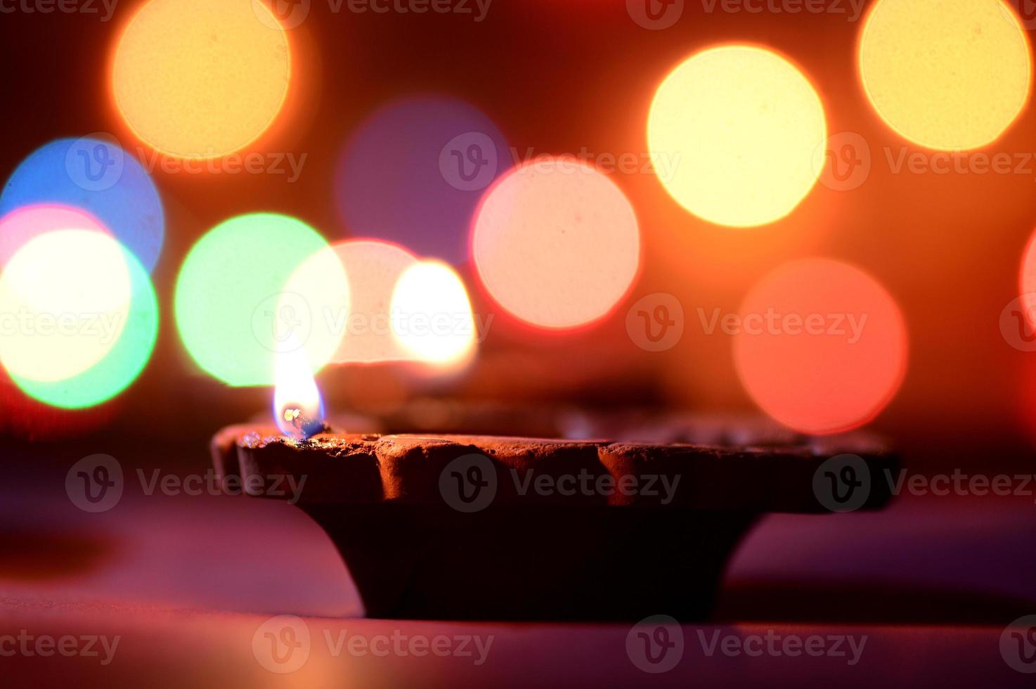 Clay diya lamps lit during Diwali Celebration. Greetings Card Design Indian Hindu Light Festival called Diwali photo