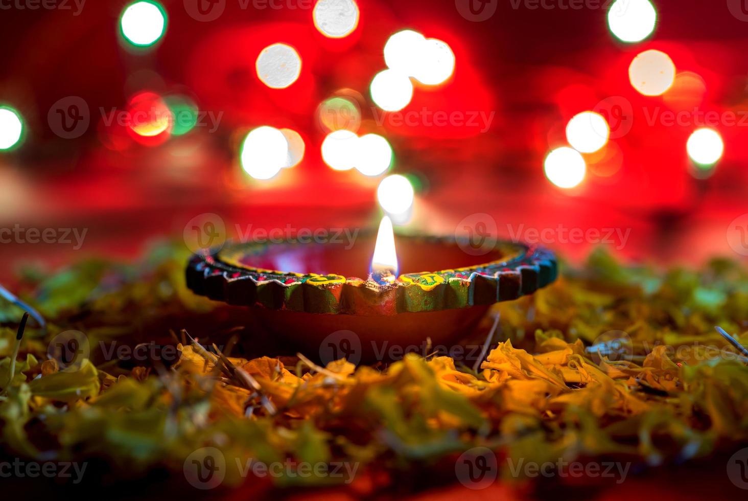 Happy Diwali - Clay Diya lamps lit during Diwali celebration. Greetings Card Design of Indian Hindu Light Festival called Diwali photo