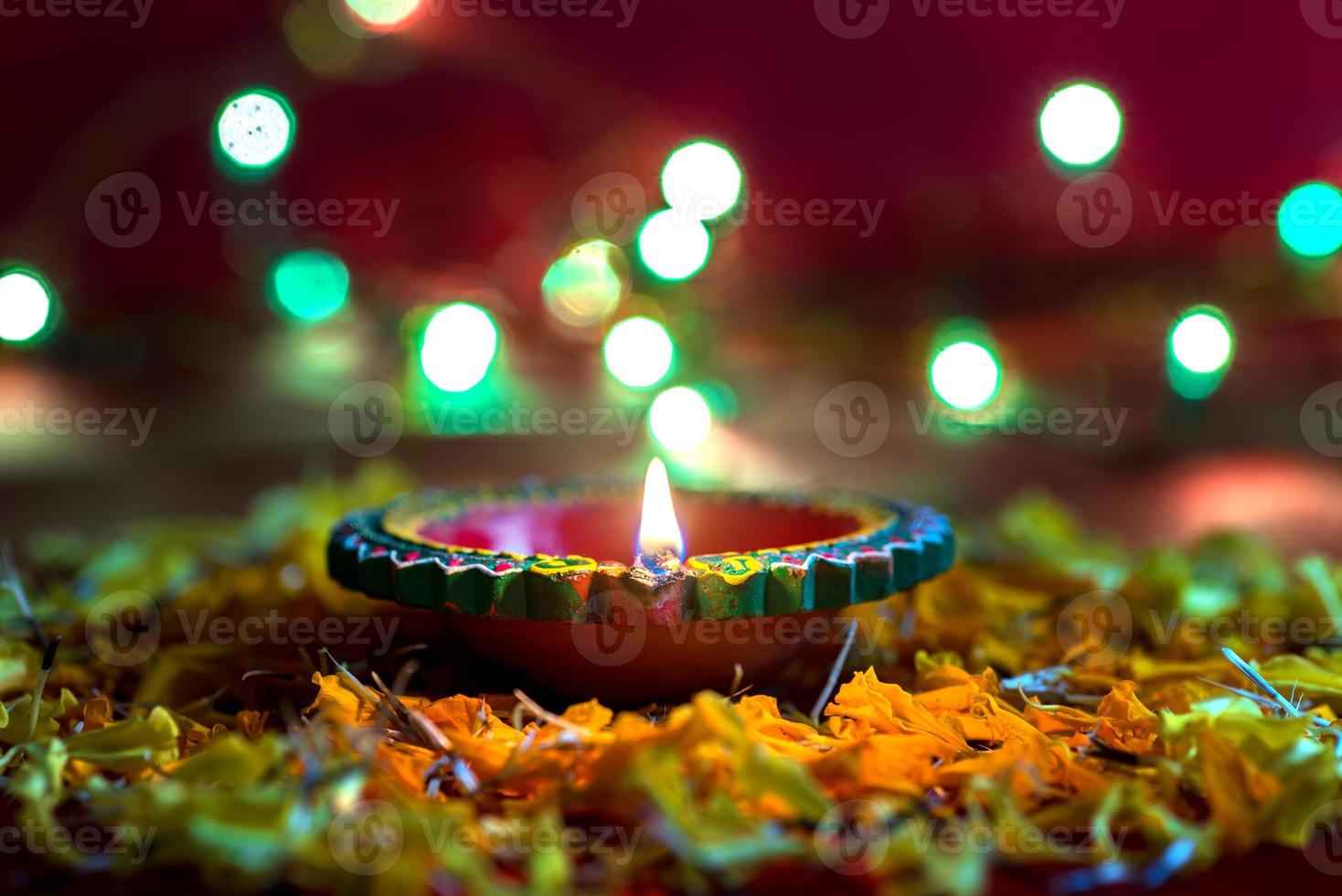 Happy Diwali - Clay Diya lamps lit during Diwali celebration. Greetings Card Design of Indian Hindu Light Festival called Diwali photo