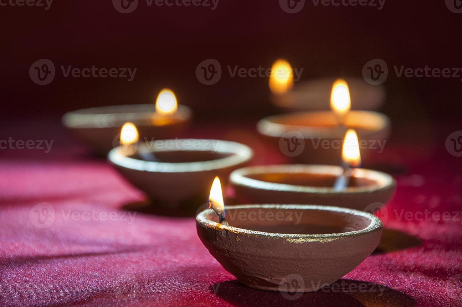 Clay diya lamps lit during Diwali Celebration. Greetings Card Design Indian Hindu Light Festival called Diwali photo