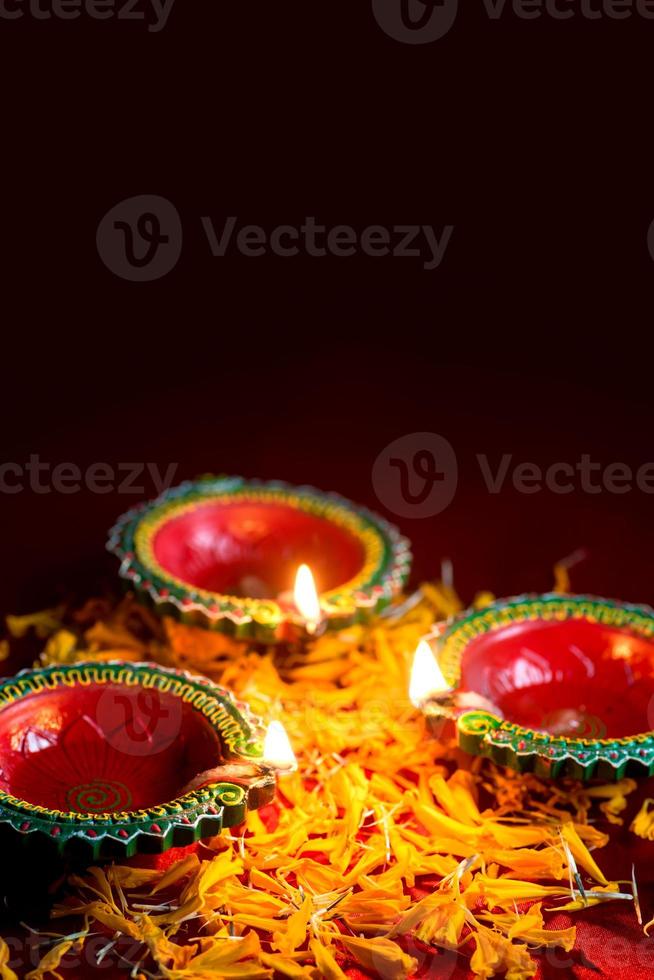 Happy Diwali - Clay Diya lamps lit during Diwali celebration. Greetings Card Design of Indian Hindu Light Festival called Diwali photo