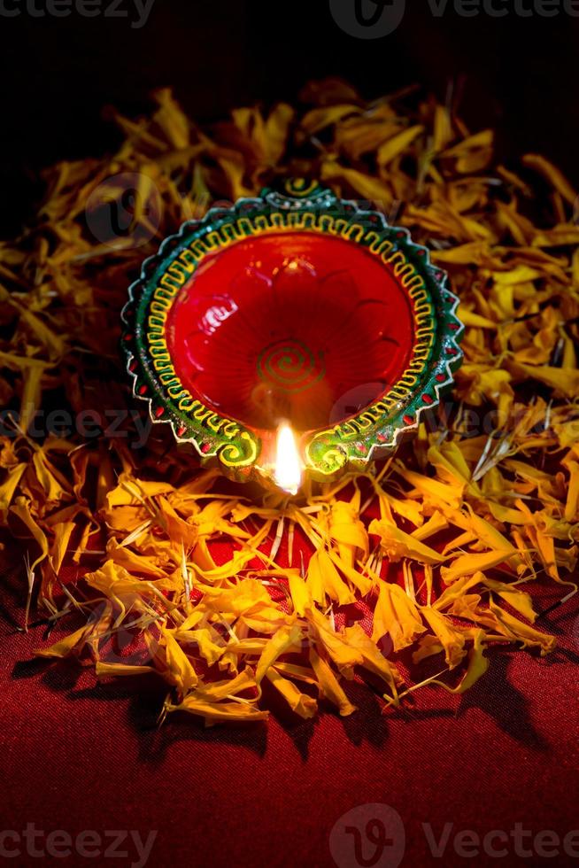 Happy Diwali - Clay Diya lamps lit during Diwali celebration. Greetings Card Design of Indian Hindu Light Festival called Diwali photo