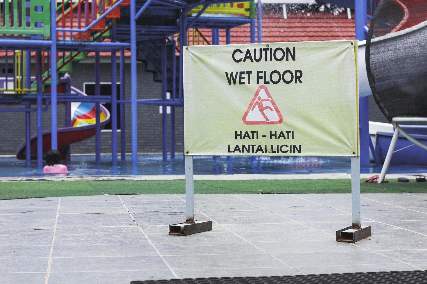 wet floor sign on the swimming pool photo