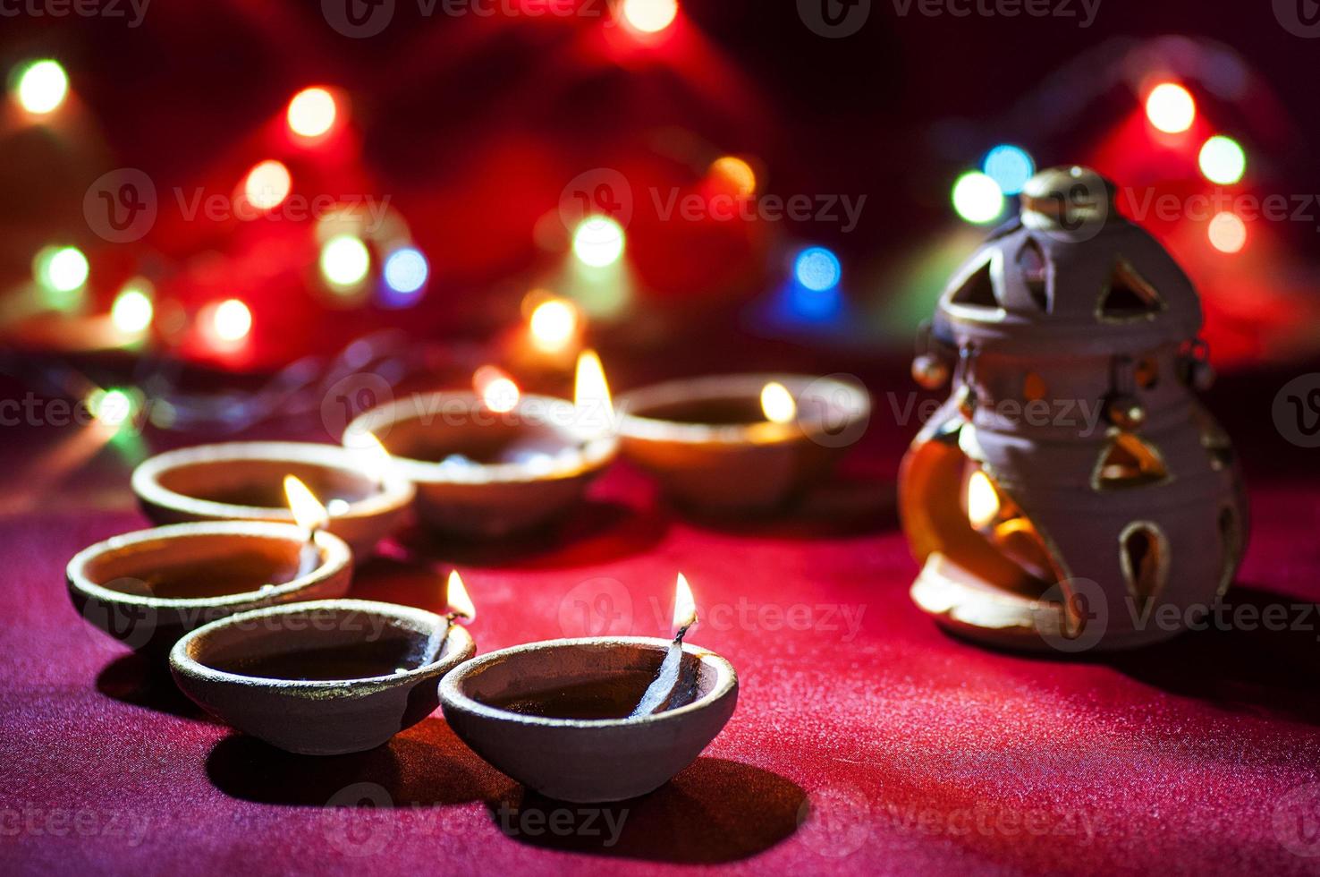 Clay diya lamps lit during Diwali Celebration. Greetings Card Design Indian Hindu Light Festival called Diwali photo