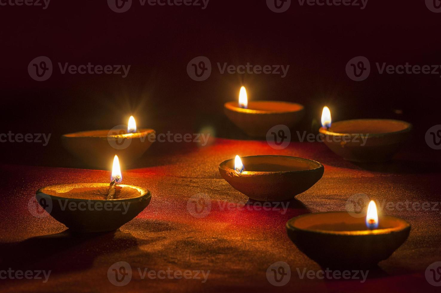 Clay diya lamps lit during Diwali Celebration. Greetings Card Design Indian Hindu Light Festival called Diwali photo