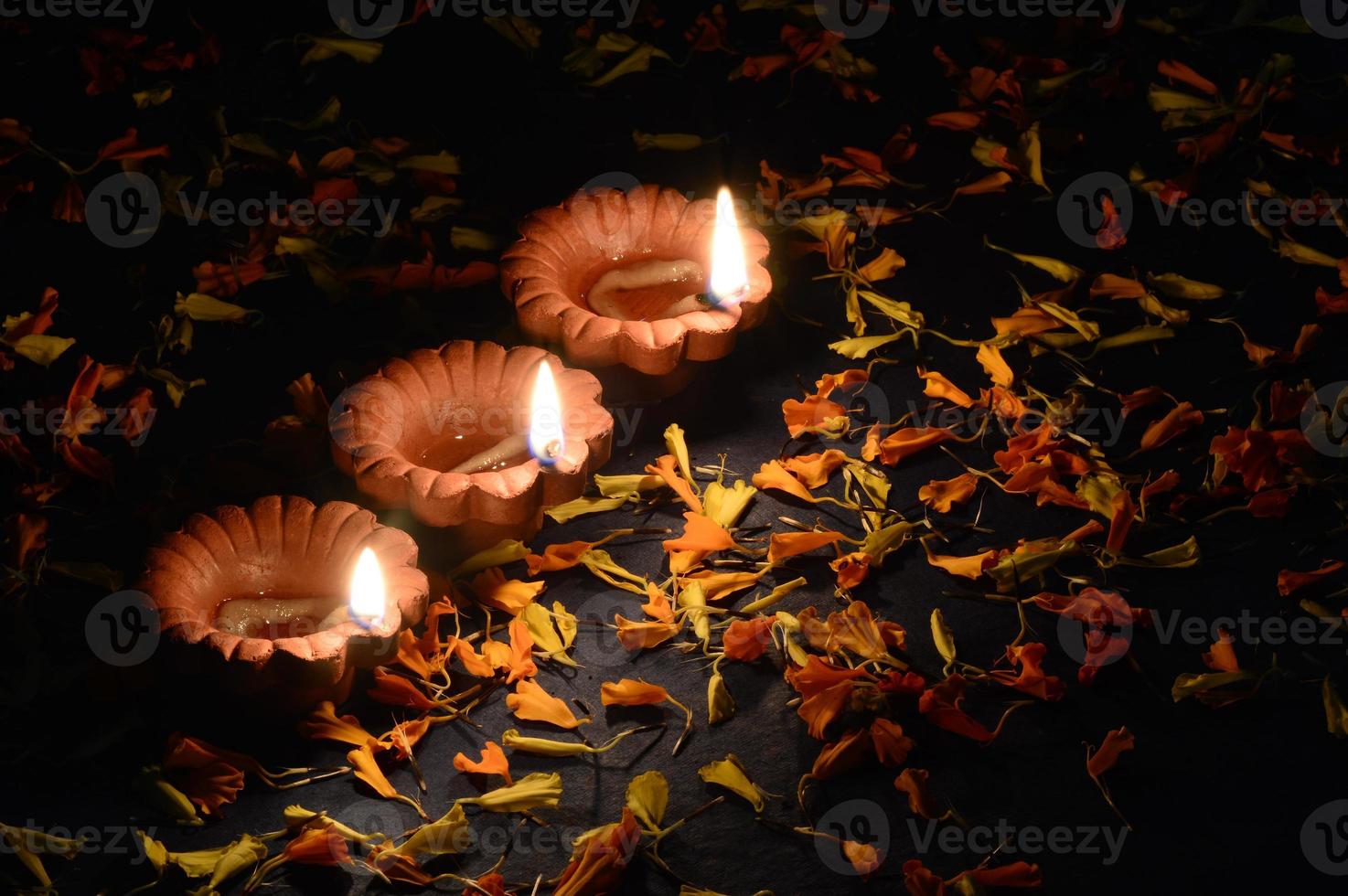 Clay diya lamps lit during Diwali Celebration. Greetings Card Design Indian Hindu Light Festival called Diwali photo