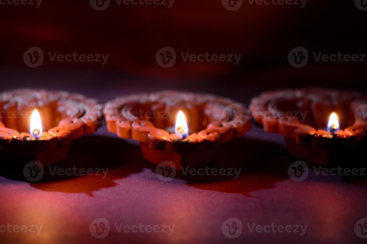 Clay diya lamps lit during Diwali Celebration. Greetings Card Design Indian Hindu Light Festival called Diwali photo