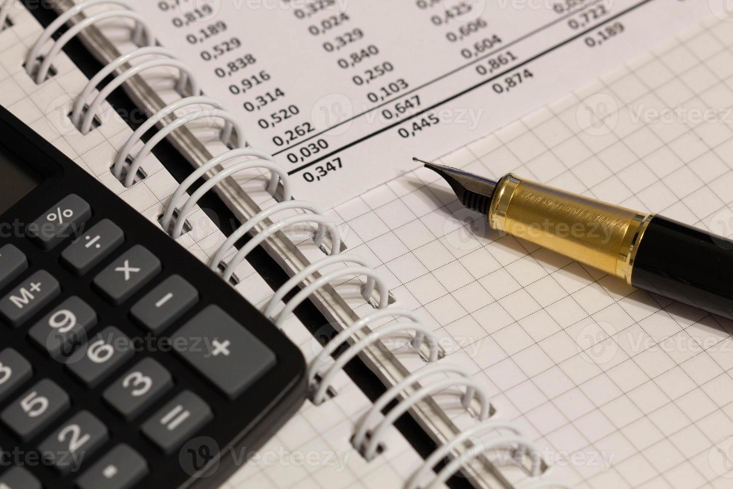 Financial report, a fountain pen and paper with numbers on the table in the office. A paper sheet full of business data. Accounts number on the data paper. Business documents. Close-up photo