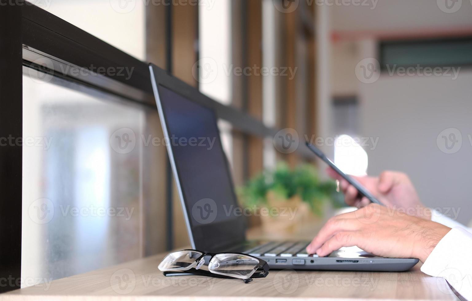 Businessman utilizing mobile smartphone and network connection photo