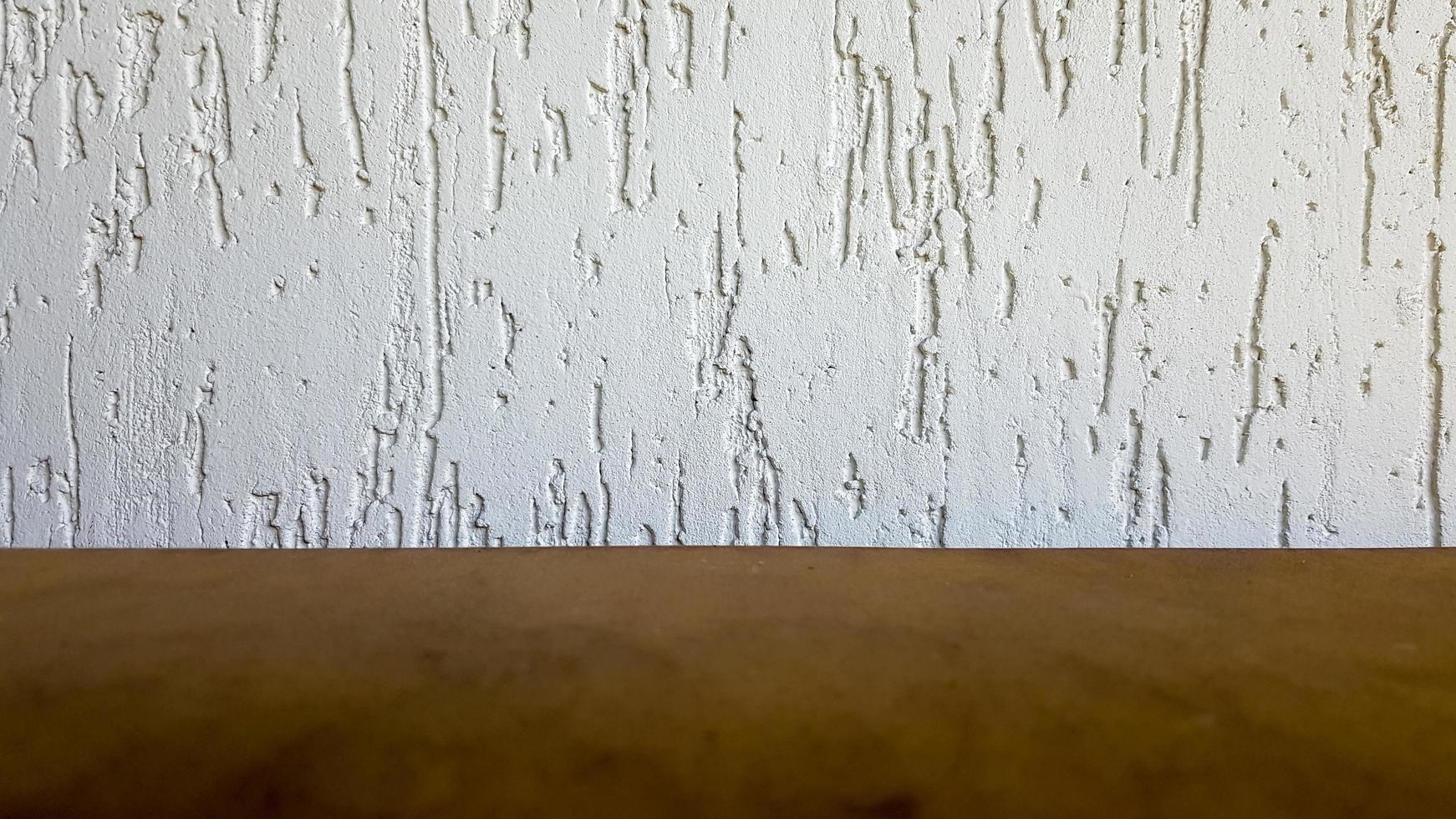 Empty top of a natural wooden table and retro white decorative wall. To display the product. Wooden table and white wall. Empty wooden tabletop, counter, shelf in the wall of the room photo