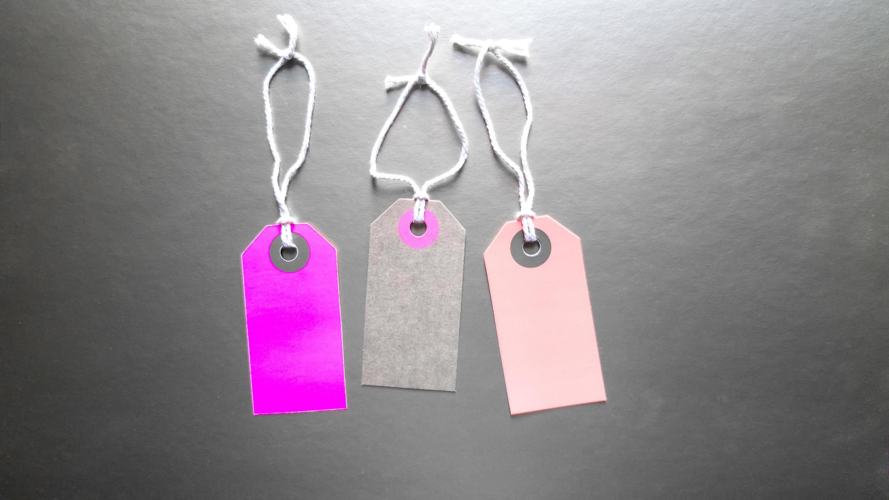 Three trendy mockup labels with clothes. Clothes sale. Background for the holiday Black Friday is an international day of shopping, stocks, discounts, sales. three tags with clothes photo