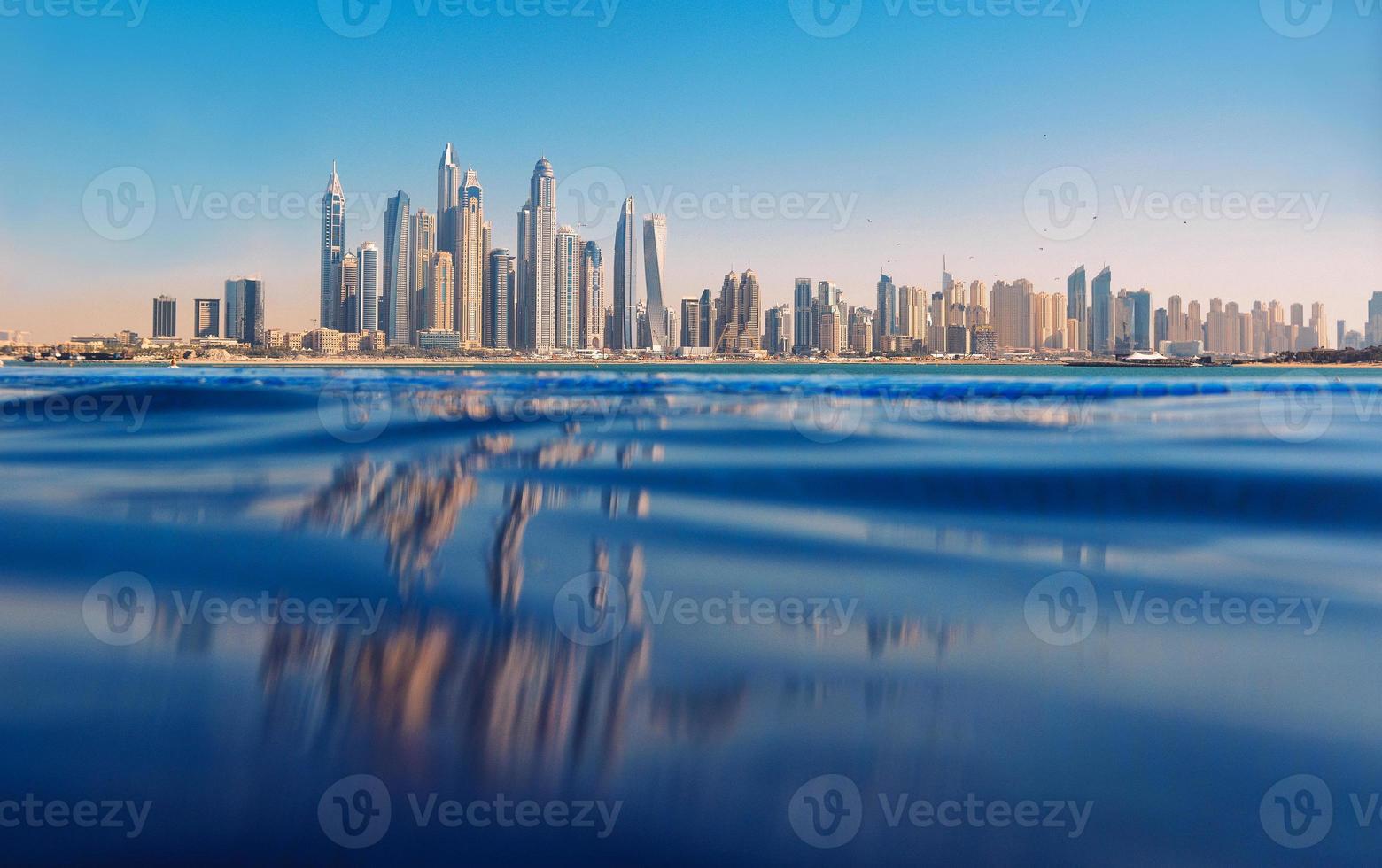 Cityscape of modern Dubai Marina with reflection in water. Travel concept photo