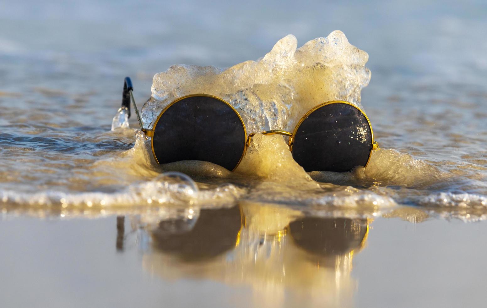 sunglasses on sand beautiful summer beach copy space Holiday concept. photo
