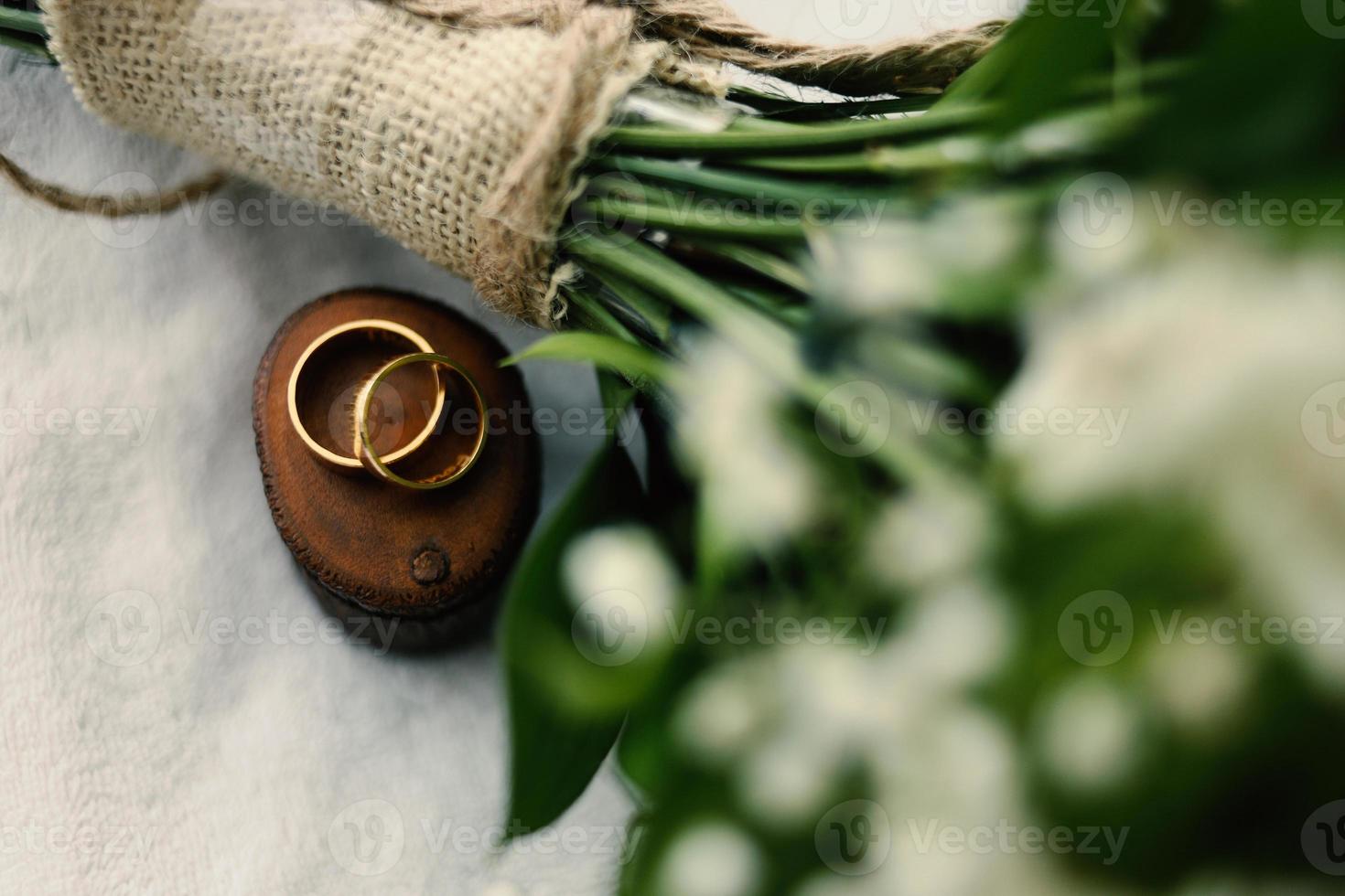 A pair of wedding rings on wood photo