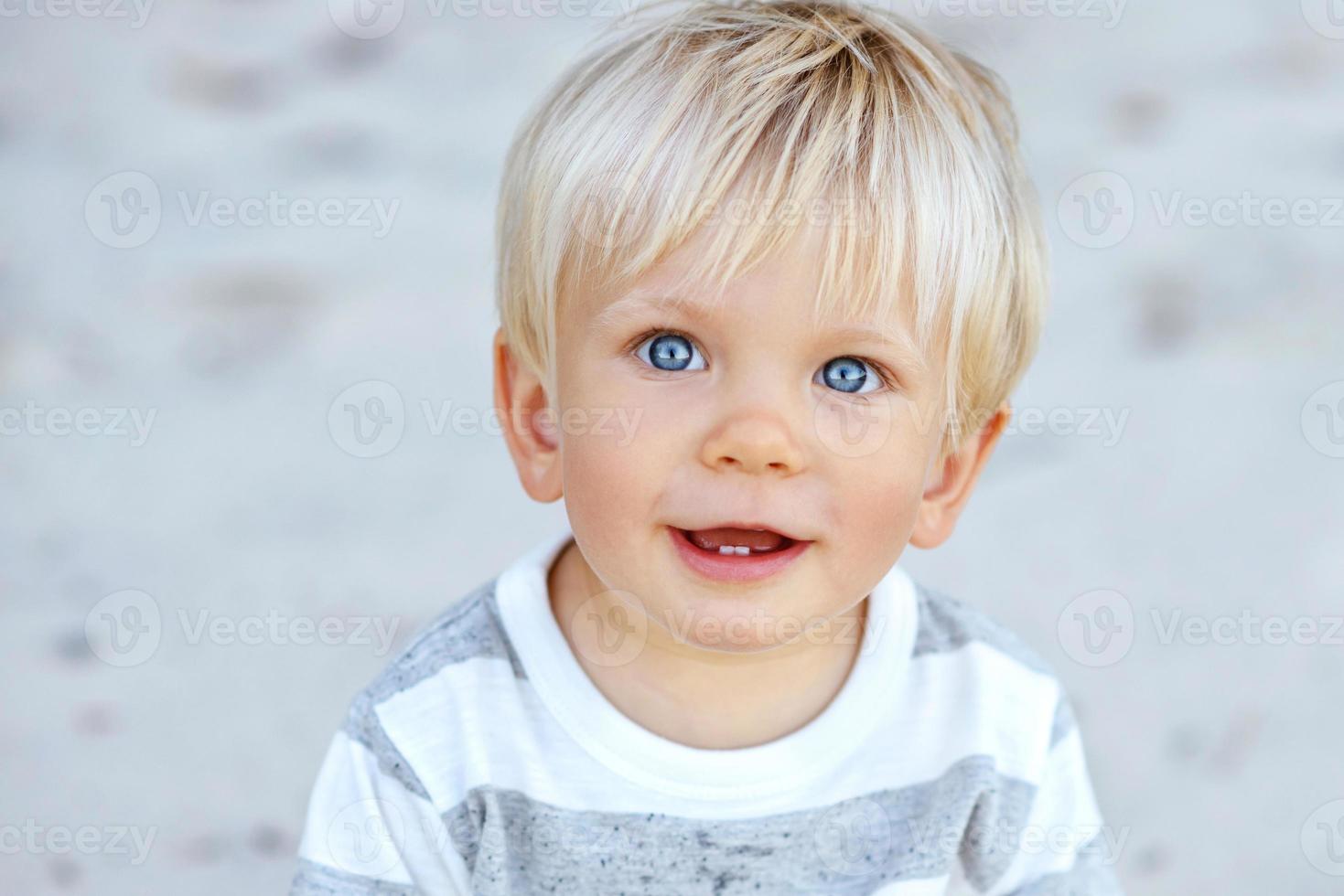 Cute boy with blond hair and blue eyes photo