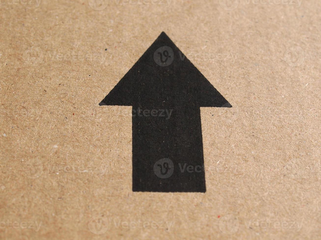 Black arrow on cardboard photo