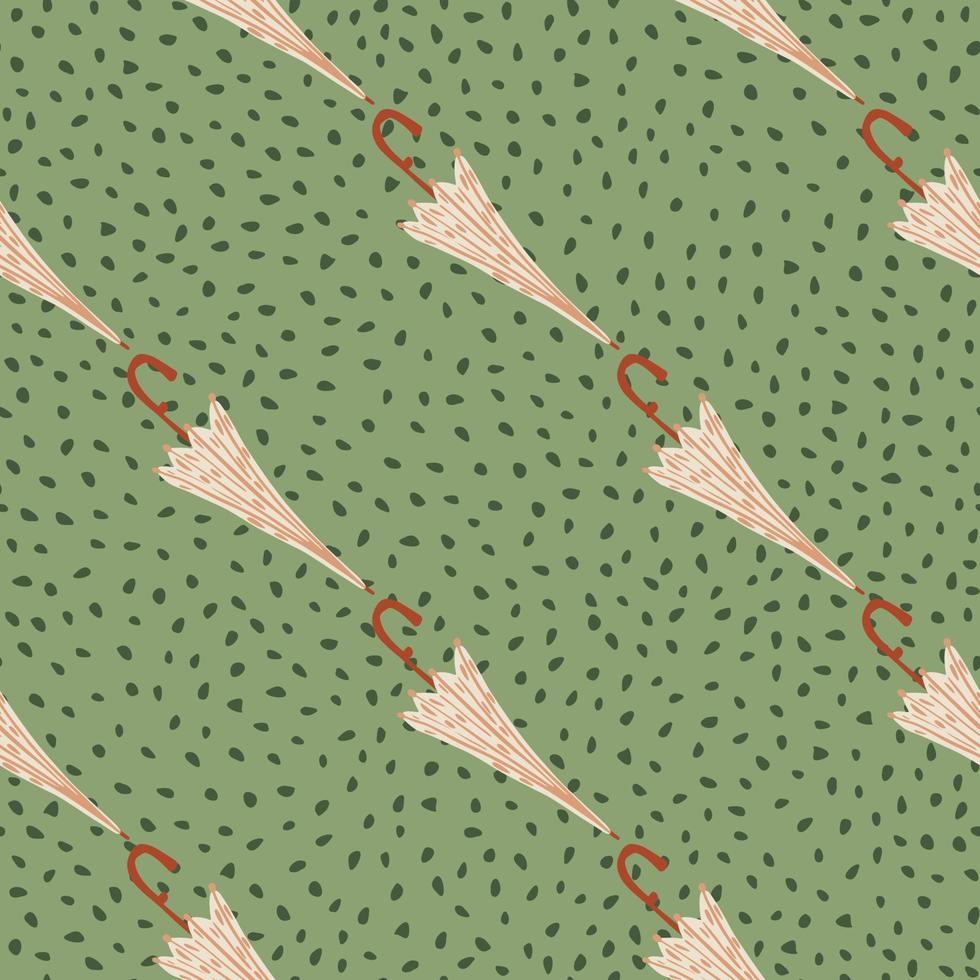 Pink colored umbrella shapes seamless fall pattern. Green dotted background. Rainy print. vector
