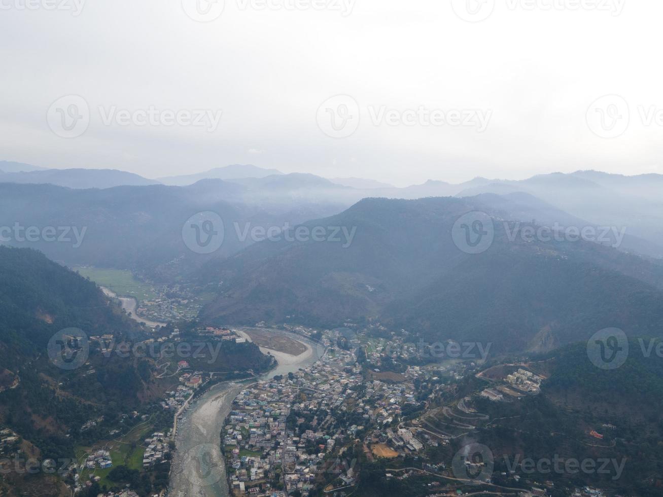 Aerial view of Bageshwar city in uttarakhand. Drone shot of a city situated in the banks of a river in mountains. photo