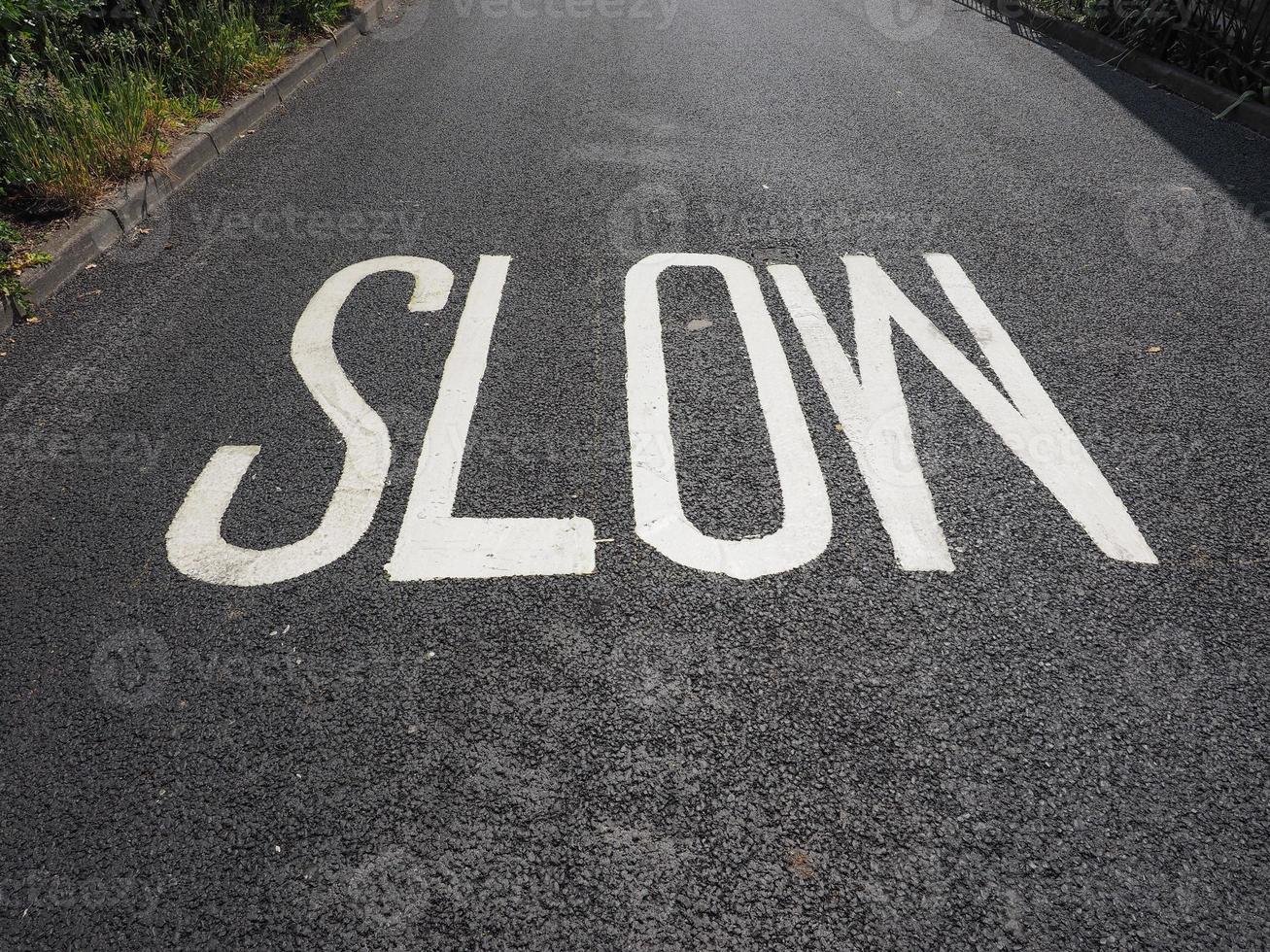 slow sign on street photo