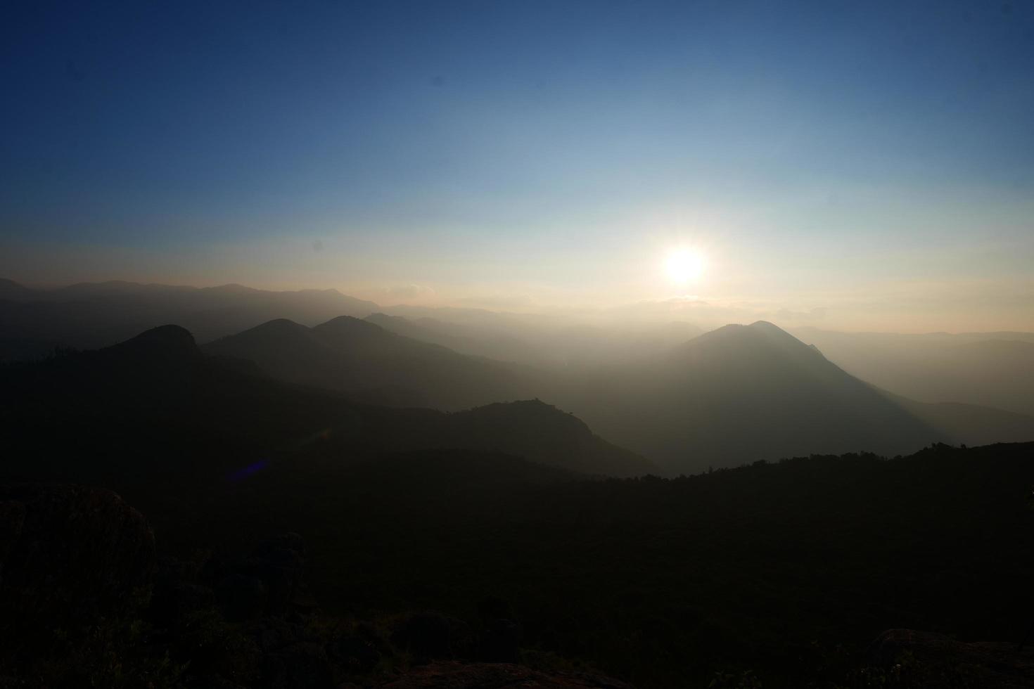 Sunset behind the hills photo