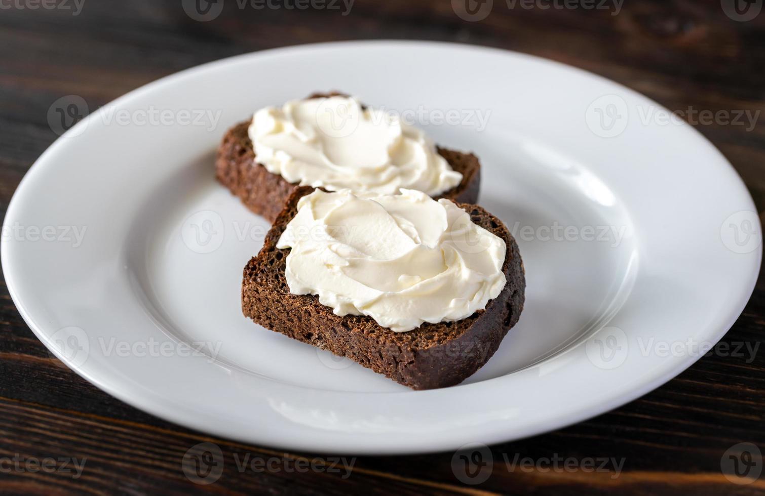 Slices of rye bread with cream cheese photo