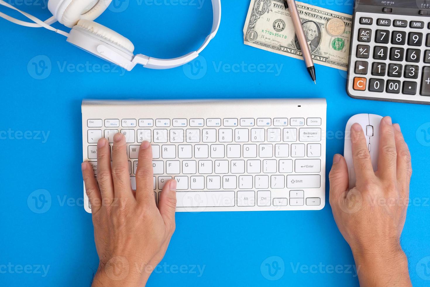 Businessman using computer, ffice desk table with computer tools and supplies. Top view with copy space, flat lay. photo
