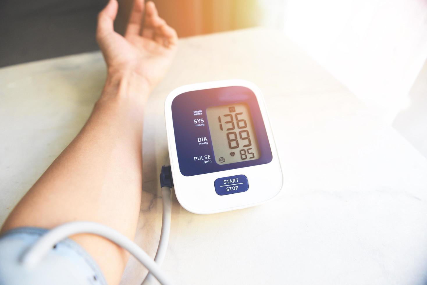 Men's health Blood Pressure Monitor Digital on wooden table , Medical electronic tonometer check blood pressure and heart rate Health and Medical concept. photo