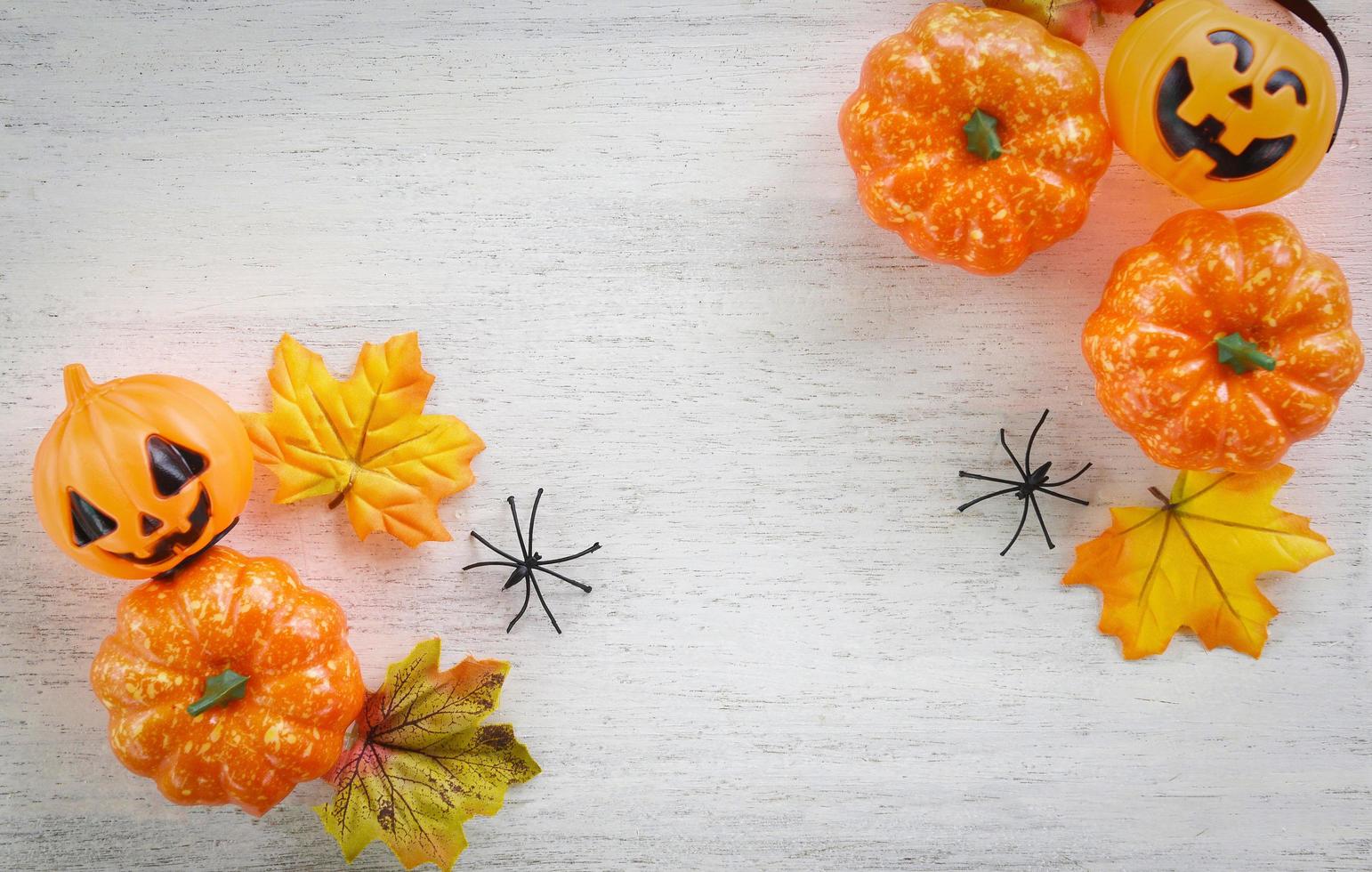 halloween background with dry leaves autumn on wooden decorated holidays festive concept jack o lantern pumpkin halloween decorations for party accessories object photo