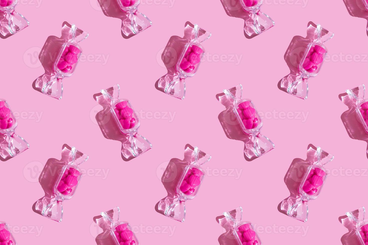 Transparent candy shaped box with sweet heart lollipops with hard shadow on pink background with copy space. The concept of Valentines day, mothers day. pattern photo